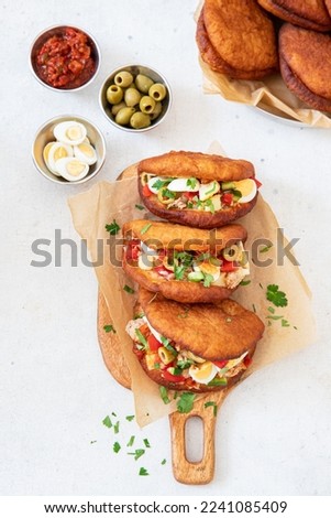 Fricasse is a savory donut  filled tuna, potato,boiled egg, olives and harissa.Traditional Tunisian food Royalty-Free Stock Photo #2241085409