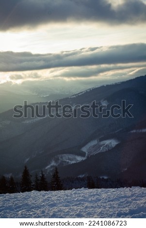 Snowy mountain on gloomy day landscape photo. Beautiful nature scenery photography with cloudscape on background. Idyllic scene. High quality picture for wallpaper, travel blog, magazine, article