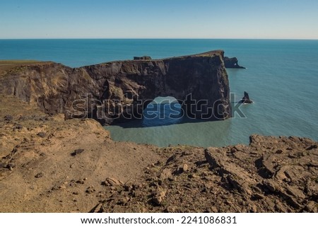 Arch cliff on ocean beach landscape photo. Beautiful nature scenery photography with blue sky on background. Idyllic scene. High quality picture for wallpaper, travel blog, magazine, article