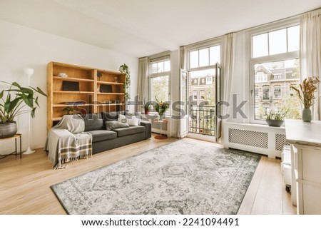 a living room with wood flooring and large windows looking out onto the cityscapeatrooms com Royalty-Free Stock Photo #2241094491