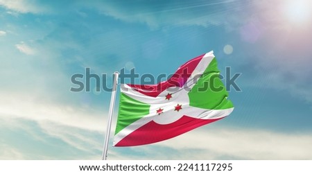 Burundi Flag on pole for Independence day. The symbol of the state on wavy cotton fabric.