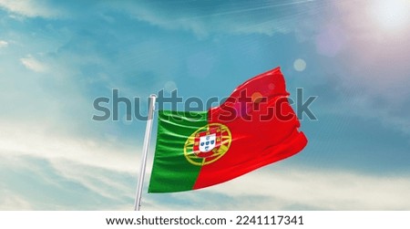 Portugal Flag on pole for Independence day. The symbol of the state on wavy cotton fabric.