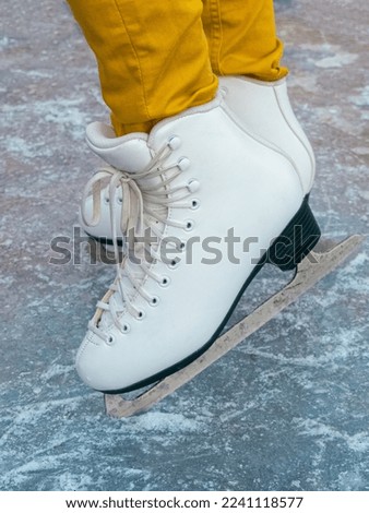 Girl in skates on ice.  Winter holidays.