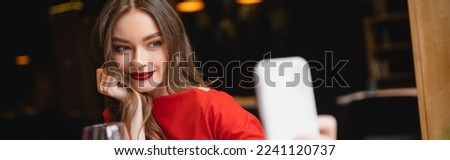 smiling young woman with red lips taking selfie on valentines day, banner