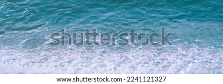 Abstract nature background Sea rippled water surface texture edge wallpaper White foam blue green turquoise