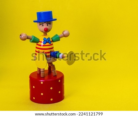 Toy clown, on a yellow background