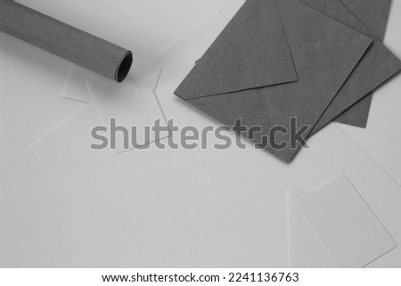 Karft Paper Roll, Envelopes, White Invitation Card Arranged on White. Brandind Design. Brand Identity Copy Space Mockup.