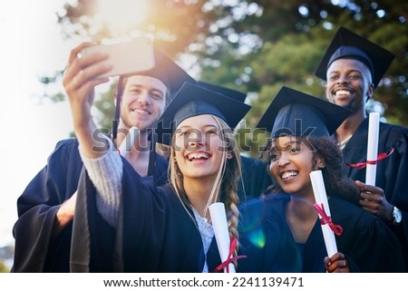 This is a day well never forget. Cropped shot of a group of university students taking a selfie on graduation day.