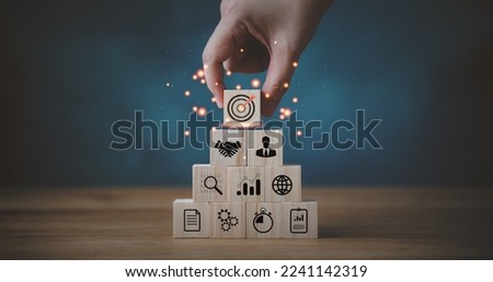 business strategy, Action plan, Goal and target, hand stack woods block step on table with icon about business strategy and Action plan. business development concept. copy space.
