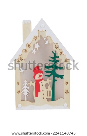 Wooden Christmas toy in the shape of a house with a white roof, snowman, Christmas isolated on white background. Front view.Home decoration for the New Year and Christmas.New Year's content.