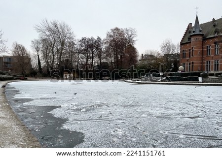 Frosted pond next to Brasserie Mariadal building in Zaventem, Belgium Royalty-Free Stock Photo #2241151761