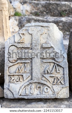 stone cross on the grave, close-up