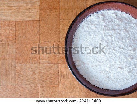 flour in a brown ceramic bowl