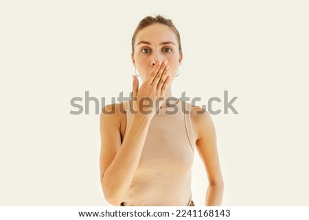 Pretty caucasian young woman accidentally told secret, covering mouth with hand having shocked, oops facial expression, isolated on white studio background. Spill the beans. Body language Royalty-Free Stock Photo #2241168143