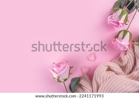 Romantic holiday flat lay. March 8 Women's Day, Valentine's Day preparation greeting card mock up. Gently pink pastel rose flowers bouquet on pink background top view copy space