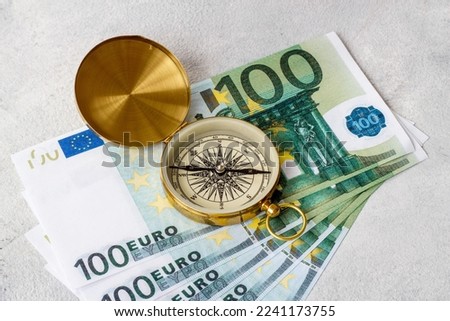 Compass and money cash. Exchange quotes of currencies concept