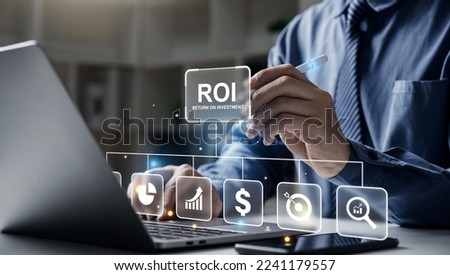 Return On Investment business technology finance Concept, Young business pointing to ROI on laptop screen.