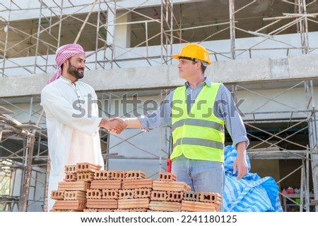 Arabic businessman teammates working together, construction engineer architect and worker looking building model and blueprint blueprint plans of Arab businessman.