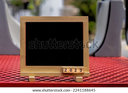 Numeric 2023 on square wooden easel. Start new year 2023 with goal plan, goal concept, action plan, strategy, new year business. Celebration welcoming the new year.