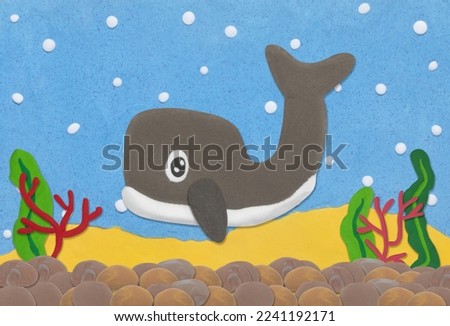 gray whale made from plasticine on colorful under water background