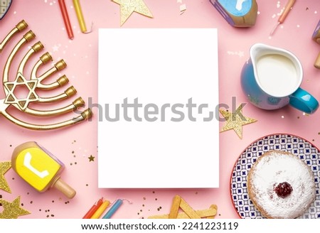 Blank card with menorah, treats, dreidels and stars for Hannukah celebration on pink background