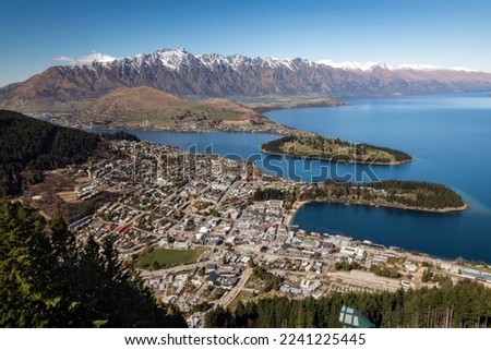 A view of Queenstown, New Zealand with the Remarkables in the background and Lake Wakatipu