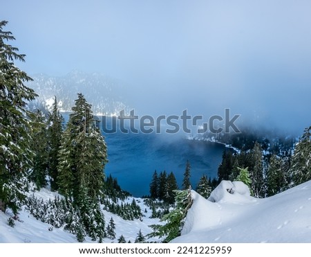 Alpine lake with snow covered mountain