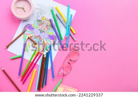 Coloring page, felt-tip pens, pencils, alarm clock and eyeglasses on pink background