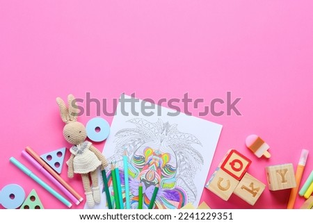 Coloring page, felt-tip pens, pencils and toys on pink background