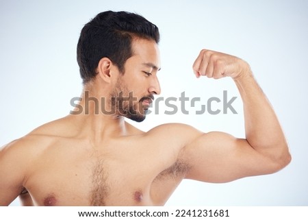Asian man, body of bicep flex on studio background in studio for muscle growth progress, healthcare wellness check or bodybuilding success. Sports athlete, coach or bodybuilder flexing arm in fitness Royalty-Free Stock Photo #2241231681