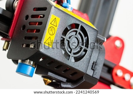 Very close-up detail of 3D printer printerhead with hotend and fan. Isolated on white background.