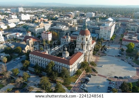 aerial shot of office buildings, city hall, hotels and apartments in the city skyline surrounded by lush green trees and plants, cars on the street, mountains in Pasadena California USA Royalty-Free Stock Photo #2241248561