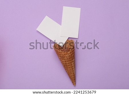 White Blank business card for branding with waffle cone on purple background. Top view
