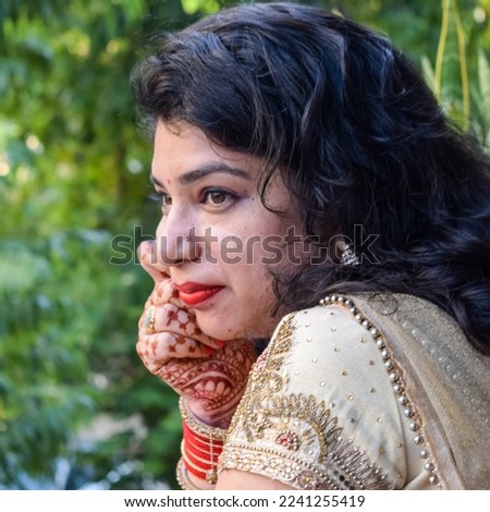 Beautiful woman dressed up as Indian tradition with henna mehndi design on her both hands to celebrate big festival of Karwa Chauth, Karwa Chauth celebrations by Indian woman for her husband