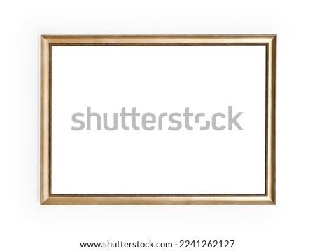 Empty golden picture frame on white wall. Copy space into frame. Isolated with clipping path