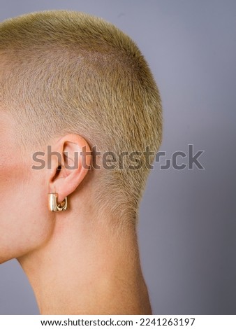 close-up shot of  woman with short blond hair and long neck  