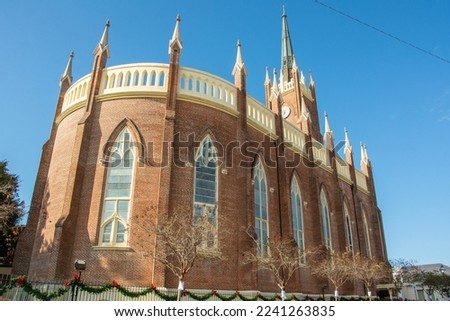 Exterior view of the St. Mary Basilica (Our Lady of Sorrows Cathedral) with semi-circular apsidal end, ornamental pinnacles, and buttresses erected in 1837 in Natchez, Mississippi, USA Royalty-Free Stock Photo #2241263835