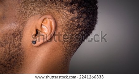 black man ear close-up macro shot Royalty-Free Stock Photo #2241266333