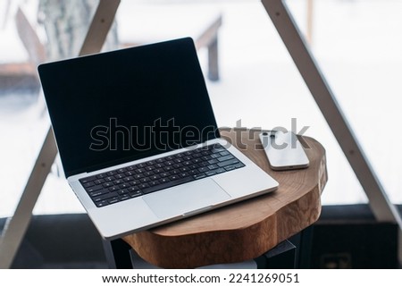 laptop on the table with space. winter outside the window Royalty-Free Stock Photo #2241269051