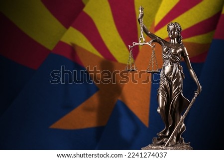 Arizaona US state flag with statue of lady justice and judicial scales in dark room. Concept of judgement and punishment, background for jury topics Royalty-Free Stock Photo #2241274037