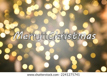 Greeting card with phrase Merry Christmas on background with golden blurred lights