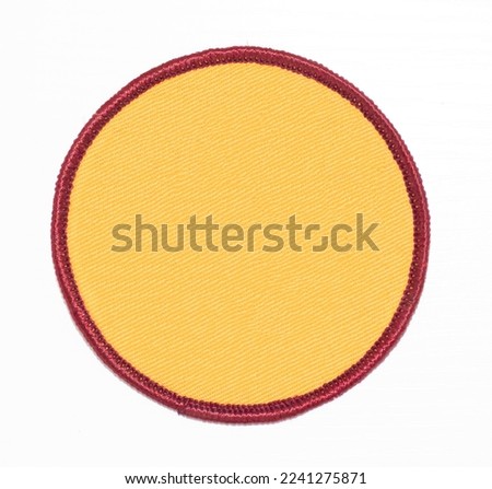 Yellow with burgundy trim circle patch isolated. Royalty-Free Stock Photo #2241275871