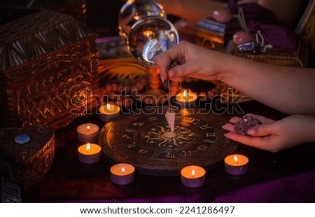 Astrology and esoteric concept. Altar with zodiac signs some stuff for horoscope, candles and mystical atmosphere