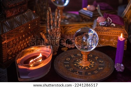 Astrology and esoteric concept. Altar with zodiac signs some stuff for horoscope, candles and mystical atmosphere