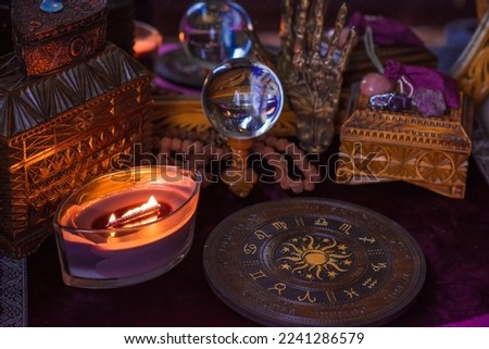 Astrology and esoteric concept. Altar with zodiac signs some stuff for horoscope, candles and mystical atmosphere
