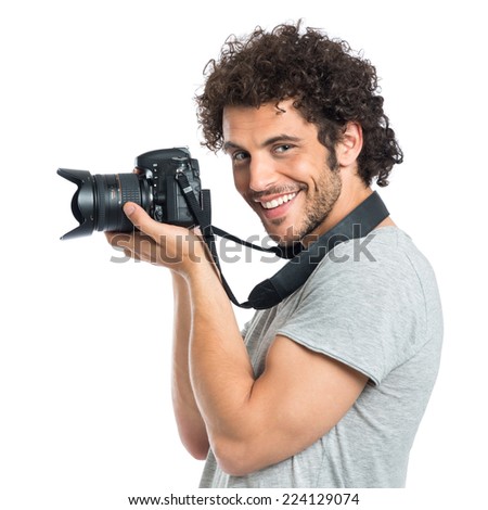 Young Happy Photographer Holding Camera Isolated On White Background Royalty-Free Stock Photo #224129074