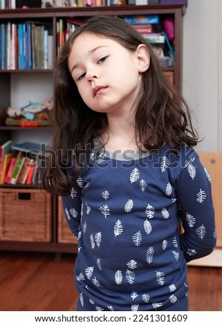 expressive young girl posing for a picture in her pajamas