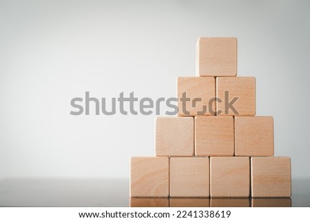 Ten Blank Wooden cubes stack in pyramid shape on right side imange over white background.,Business design,financial,education,abstract,logo,text concept.