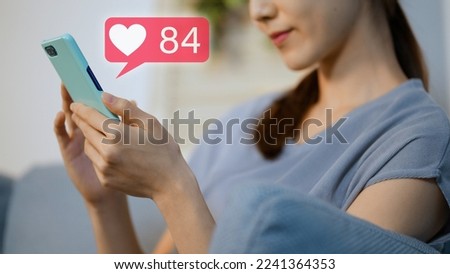 Young woman operating a smartphone at night