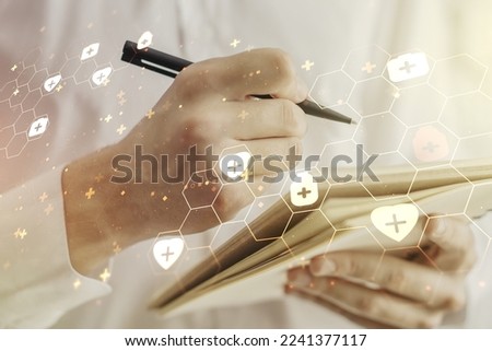Creative concept of abstract medical illustration and man hand writing in notebook on background. Medicine and healthcare concept. Multiexposure